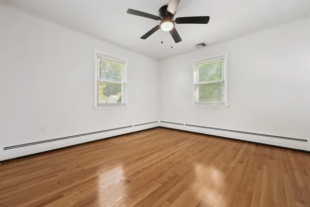 wooden floor in an empty room with a window