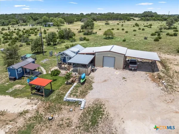 an aerial view of a house with a yard