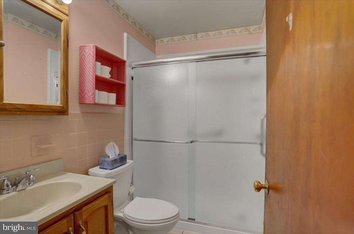 907 Cherokee Trail Frederick, MD 21701 - Photo 13 of 34 a white toilet sitting next to a bathroom sink