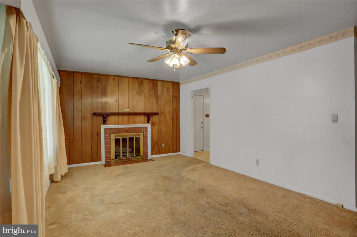 907 Cherokee Trail Frederick, MD 21701 - Photo 6 of 34 a view of an empty room with a fireplace and a window