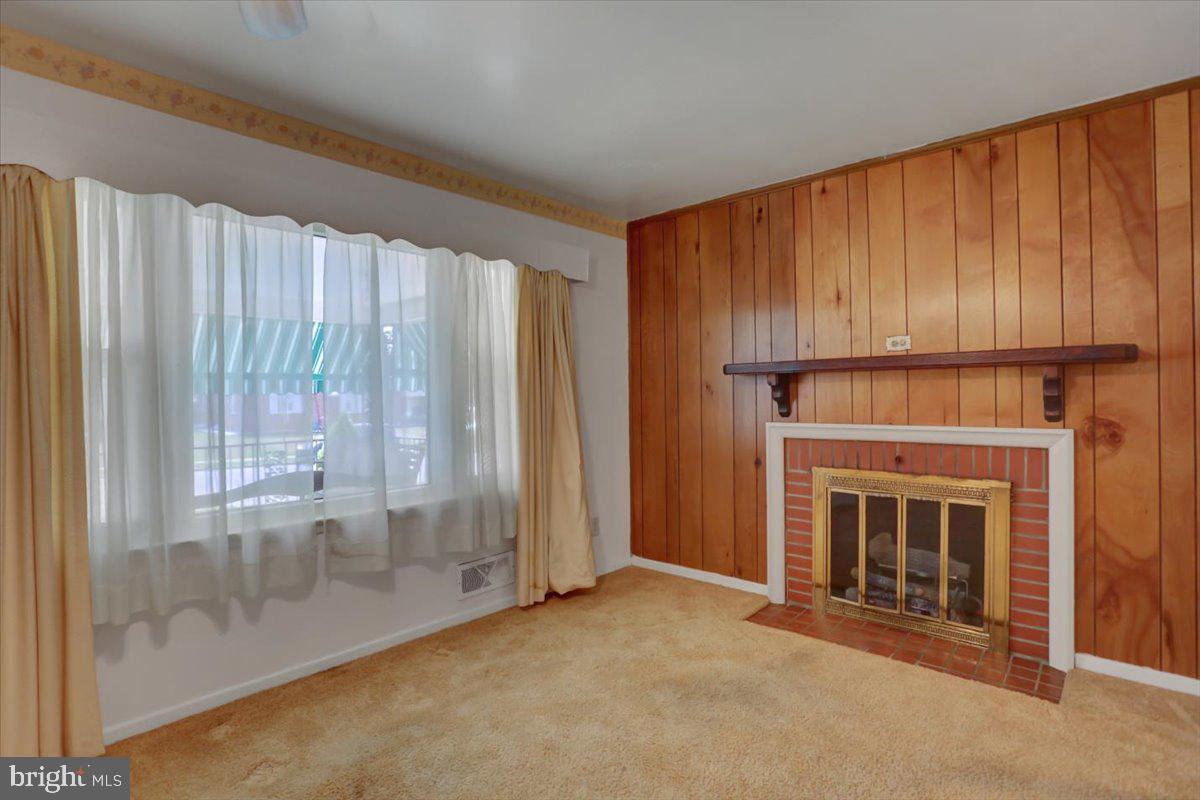 907 Cherokee Trail Frederick, MD 21701 - Photo 8 of 34 a view of an empty room with a fireplace and a window