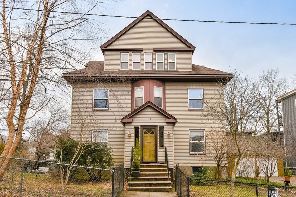 61 Montebello Road Boston, MA 02130 - Photo 1 of 35 a view of a house with wooden fence next to a road