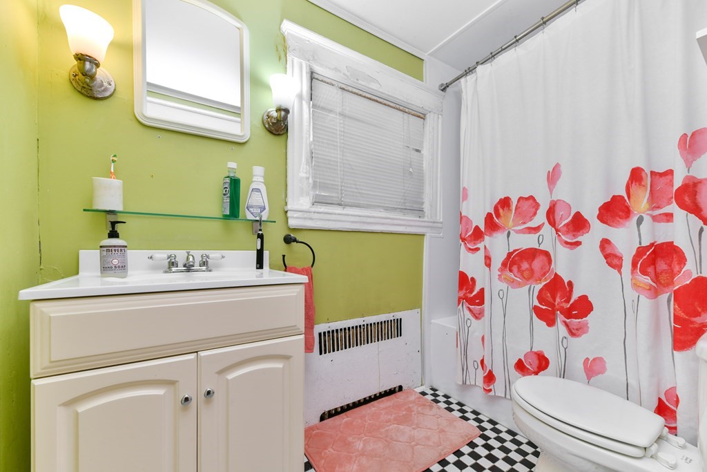 61 Montebello Road Boston, MA 02130 - Photo 13 of 35 a bathroom with a sink and a shower curtain