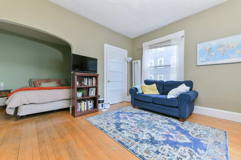 61 Montebello Road Boston, MA 02130 - Photo 17 of 35 a bedroom with furniture and a wooden floor