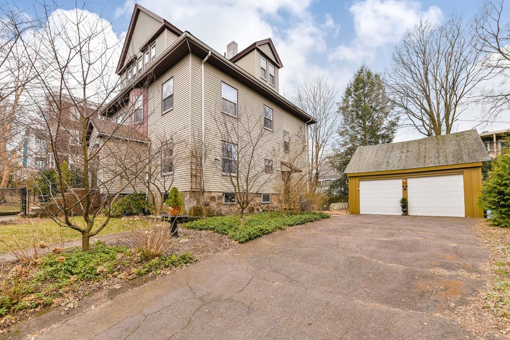 61 Montebello Road Boston, MA 02130 - Photo 2 of 35 a view of a house with a yard and garage