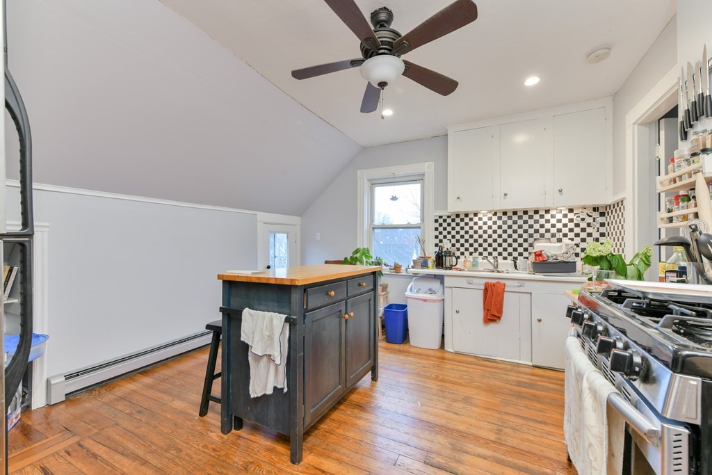 61 Montebello Road Boston, MA 02130 - Photo 31 of 35 a kitchen with a sink appliances and wooden floor