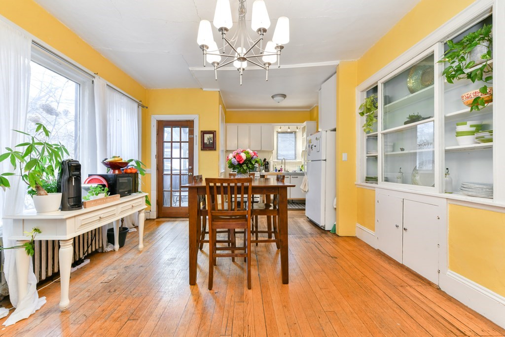 61 Montebello Road Boston, MA 02130 - Photo 8 of 35 a view of a dining room with furniture and a chandelier