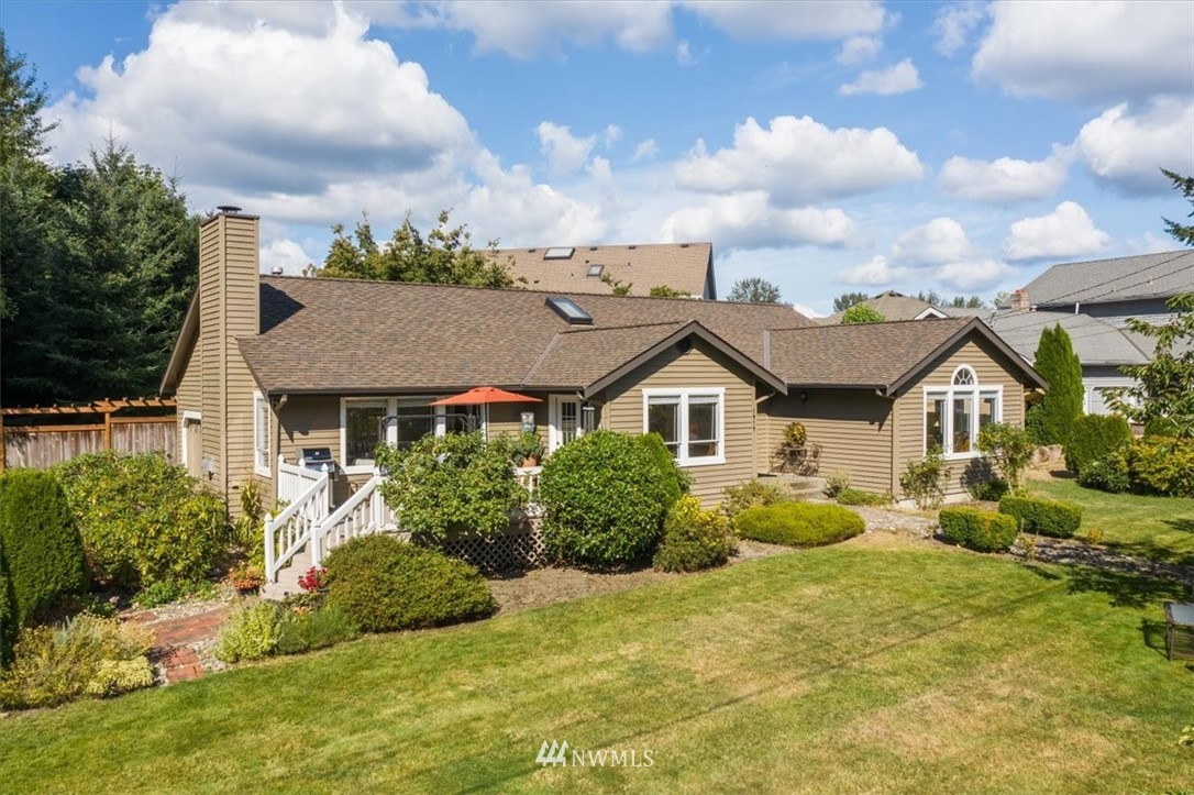 1919 243rd Place Southwest Bothell, WA 98021 - Photo 1 of 39 a front view of a house with a yard