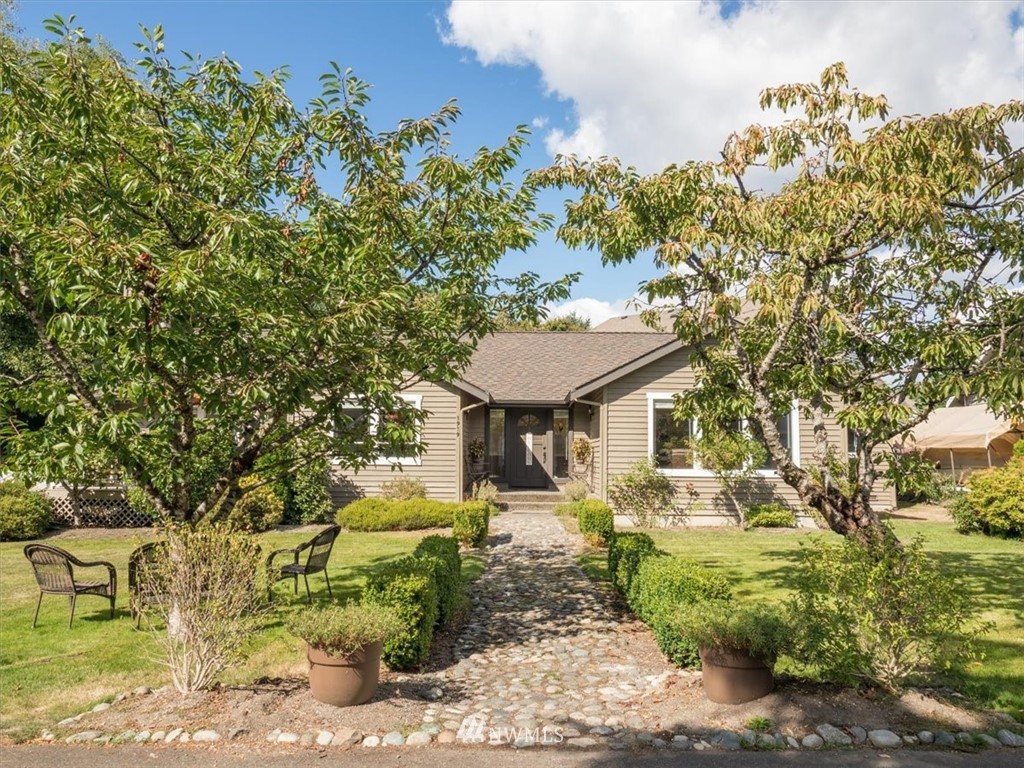1919 243rd Place Southwest Bothell, WA 98021 - Photo 2 of 39 a front view of a house with garden