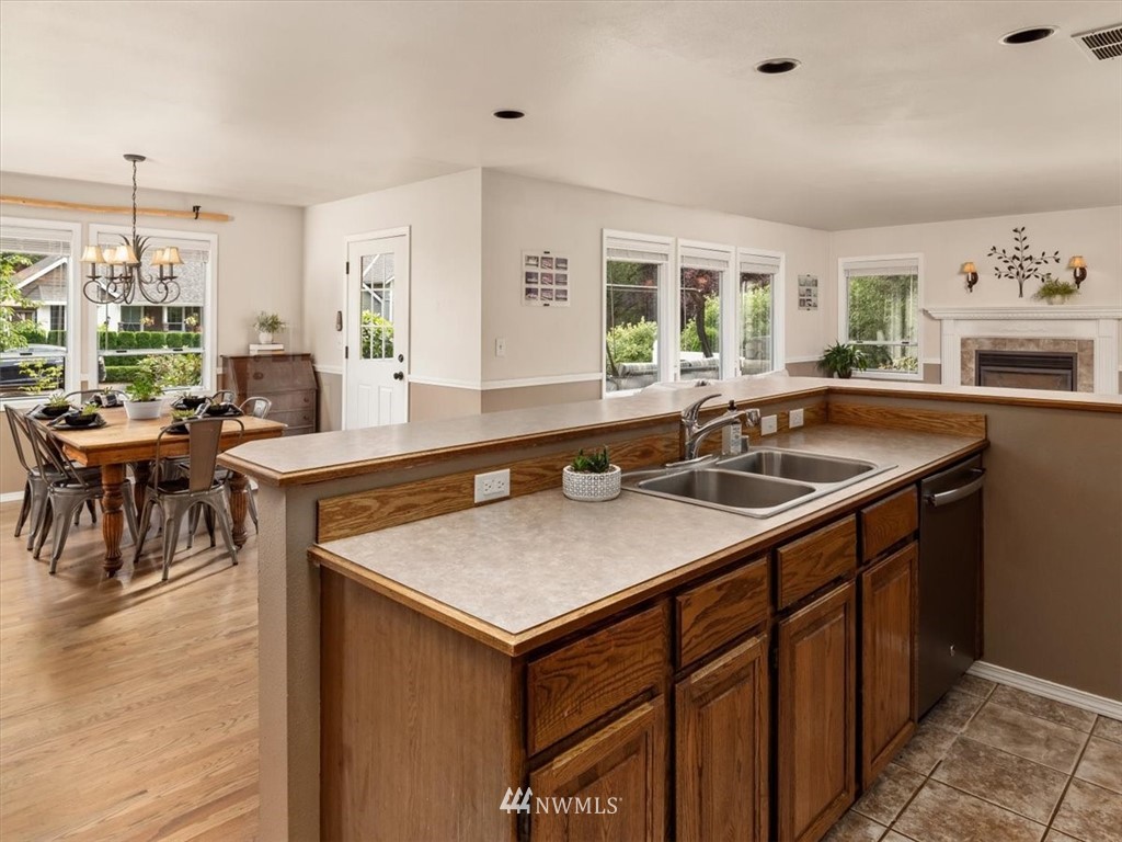 1919 243rd Place Southwest Bothell, WA 98021 - Photo 11 of 39 a kitchen with a sink a counter and chairs