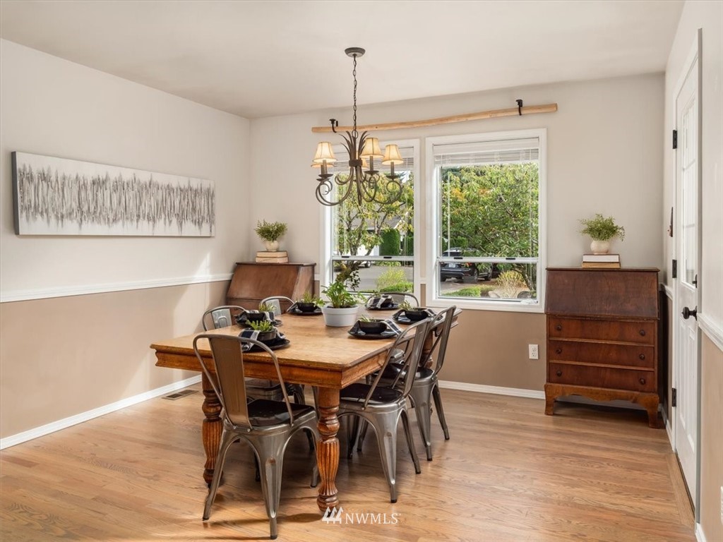1919 243rd Place Southwest Bothell, WA 98021 - Photo 12 of 39 a view of a dining room with furniture window and wooden floor