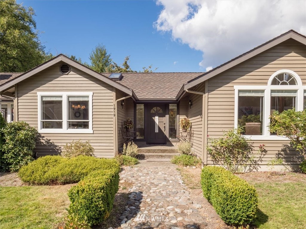1919 243rd Place Southwest Bothell, WA 98021 - Photo 3 of 39 a front view of a house with a yard and potted plants