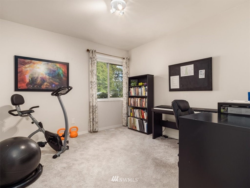 1919 243rd Place Southwest Bothell, WA 98021 - Photo 24 of 39 a work room with furniture and a flat screen tv