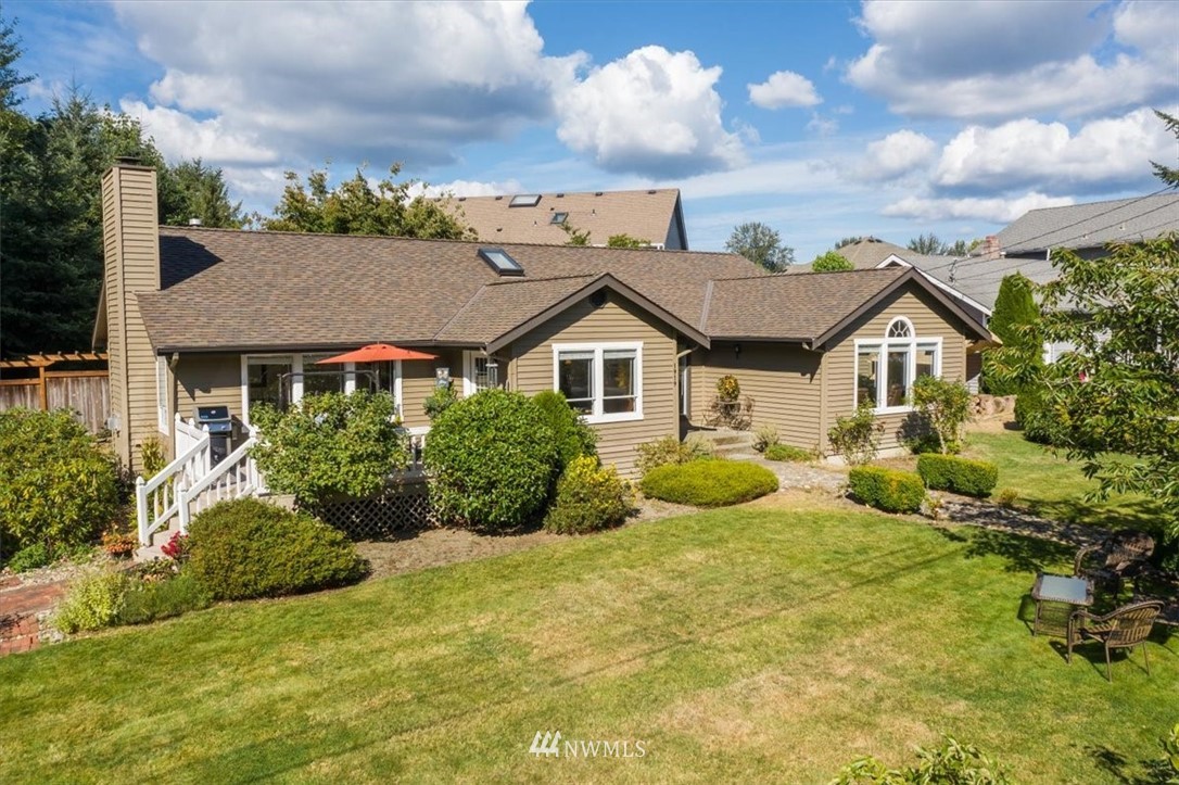 1919 243rd Place Southwest Bothell, WA 98021 - Photo 33 of 39 a view of a house with pool and garden