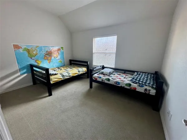 a bedroom with a bed lamp and a dresser