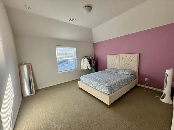 an empty room with a fireplace and a mirror