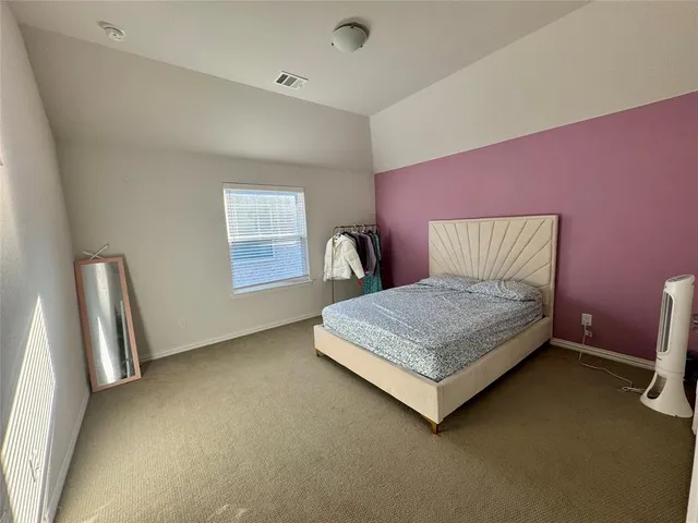 an empty room with a fireplace and a mirror