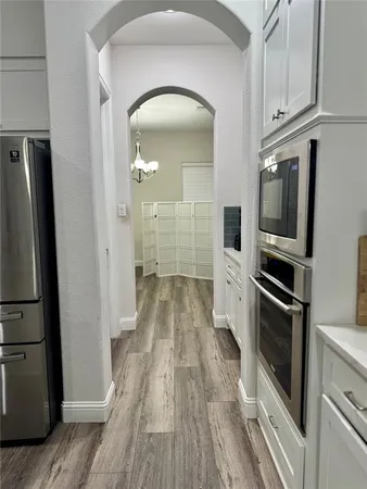 a kitchen with kitchen island a sink stove and refrigerator