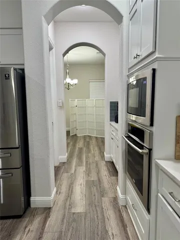 a kitchen with kitchen island a sink stove and refrigerator