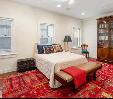 a living room with furniture a rug and a window
