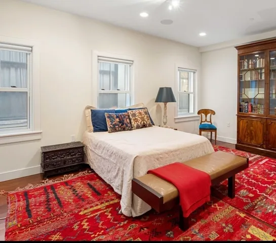 a living room with furniture a rug and a window