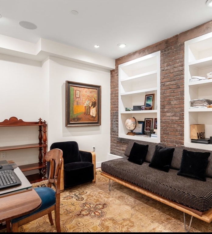 1-3 Winter Place, Unit 3 Boston, MA 02108 - Photo 14 of 23 a living room with furniture a rug and a window