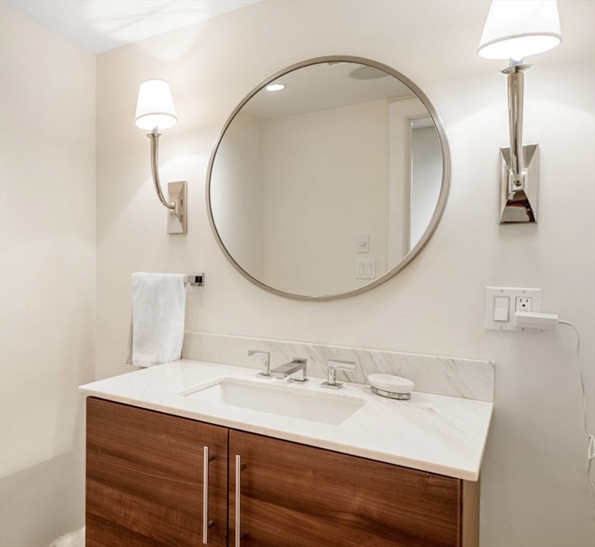 1-3 Winter Place, Unit 3 Boston, MA 02108 - Photo 19 of 23 a bathroom with a sink and a mirror