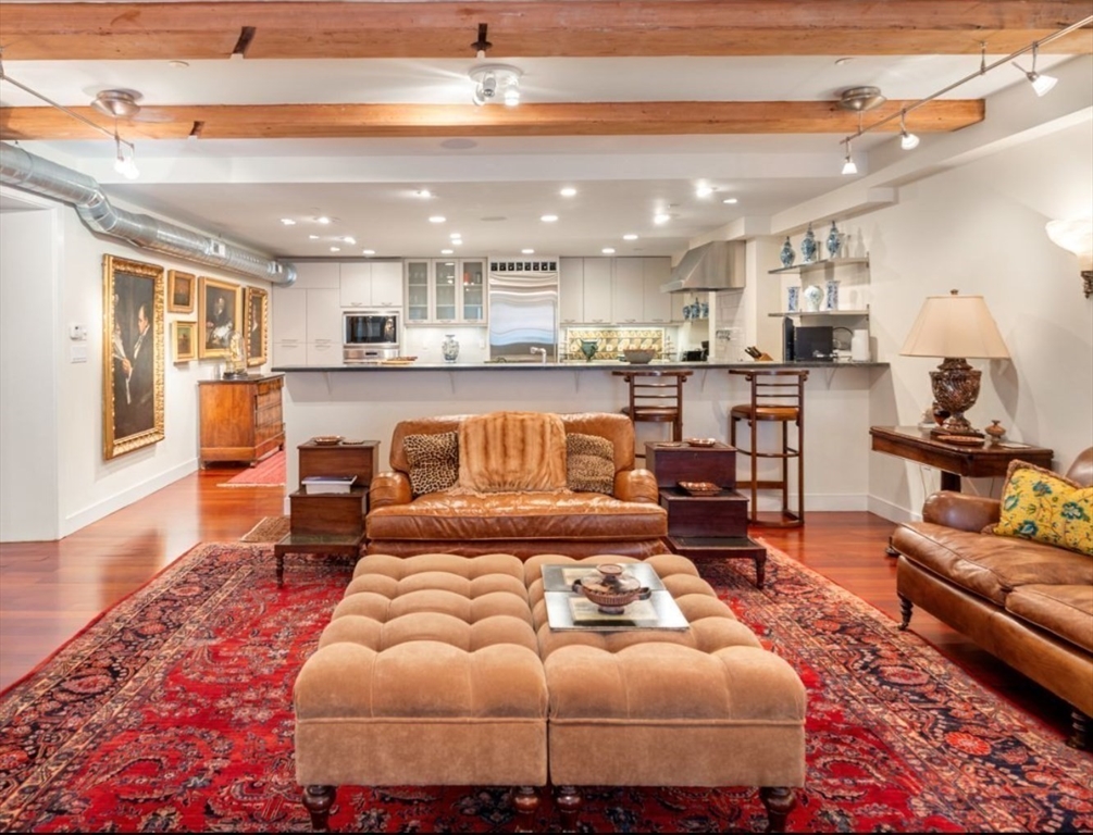 1-3 Winter Place, Unit 3 Boston, MA 02108 - Photo 4 of 23 a living room with furniture and kitchen view