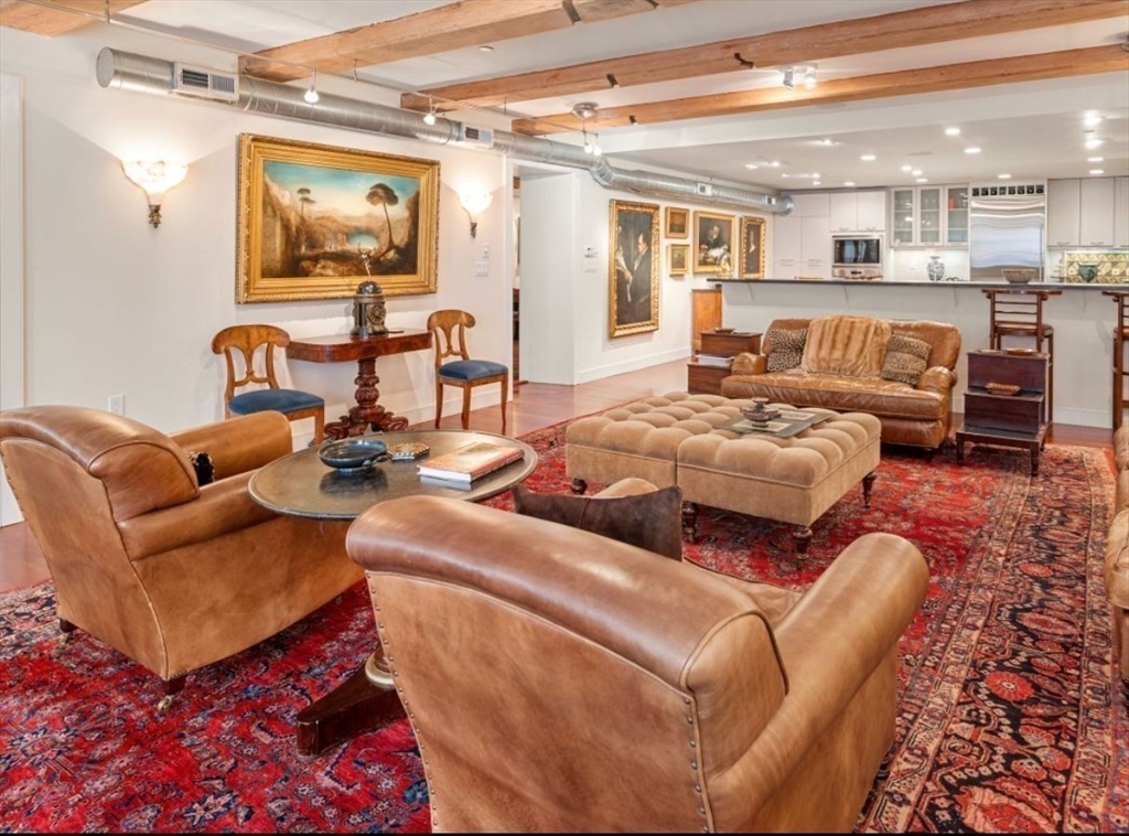 1-3 Winter Place, Unit 3 Boston, MA 02108 - Photo 5 of 23 a living room with furniture kitchen view and a large window