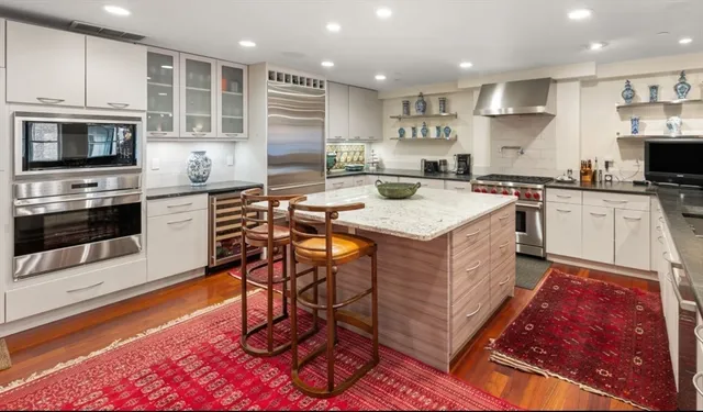 a kitchen with stainless steel appliances granite countertop a stove and a sink