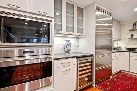 a stove top oven sitting inside of a kitchen