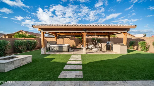 a view of a house with a backyard