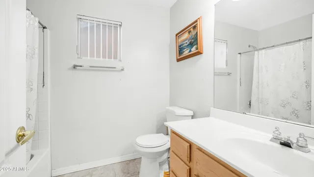 a bedroom with a bed and a flat tv screen next to a large window