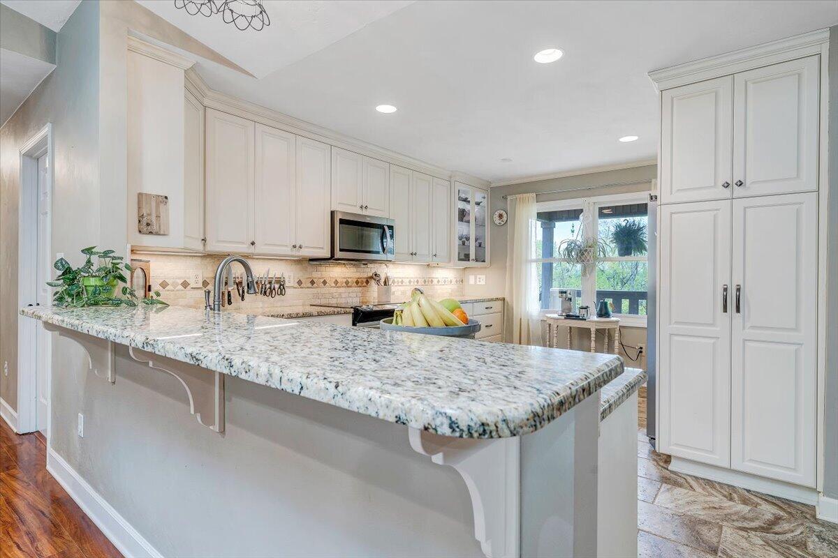 856 Ridge Mountain Drive Boones Mill, VA 24065 - Photo 12 of 66 a kitchen with granite countertop kitchen island a sink appliances and cabinets