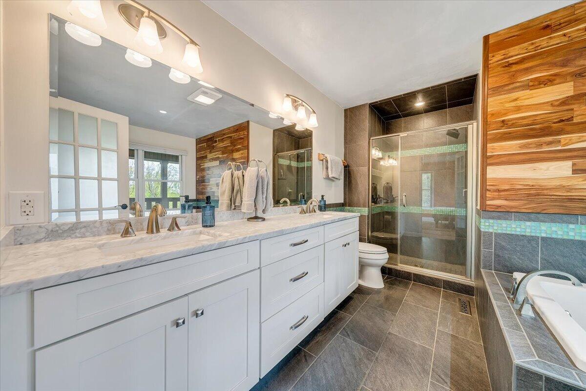 856 Ridge Mountain Drive Boones Mill, VA 24065 - Photo 26 of 66 a bathroom with a double vanity sink and mirror with shower