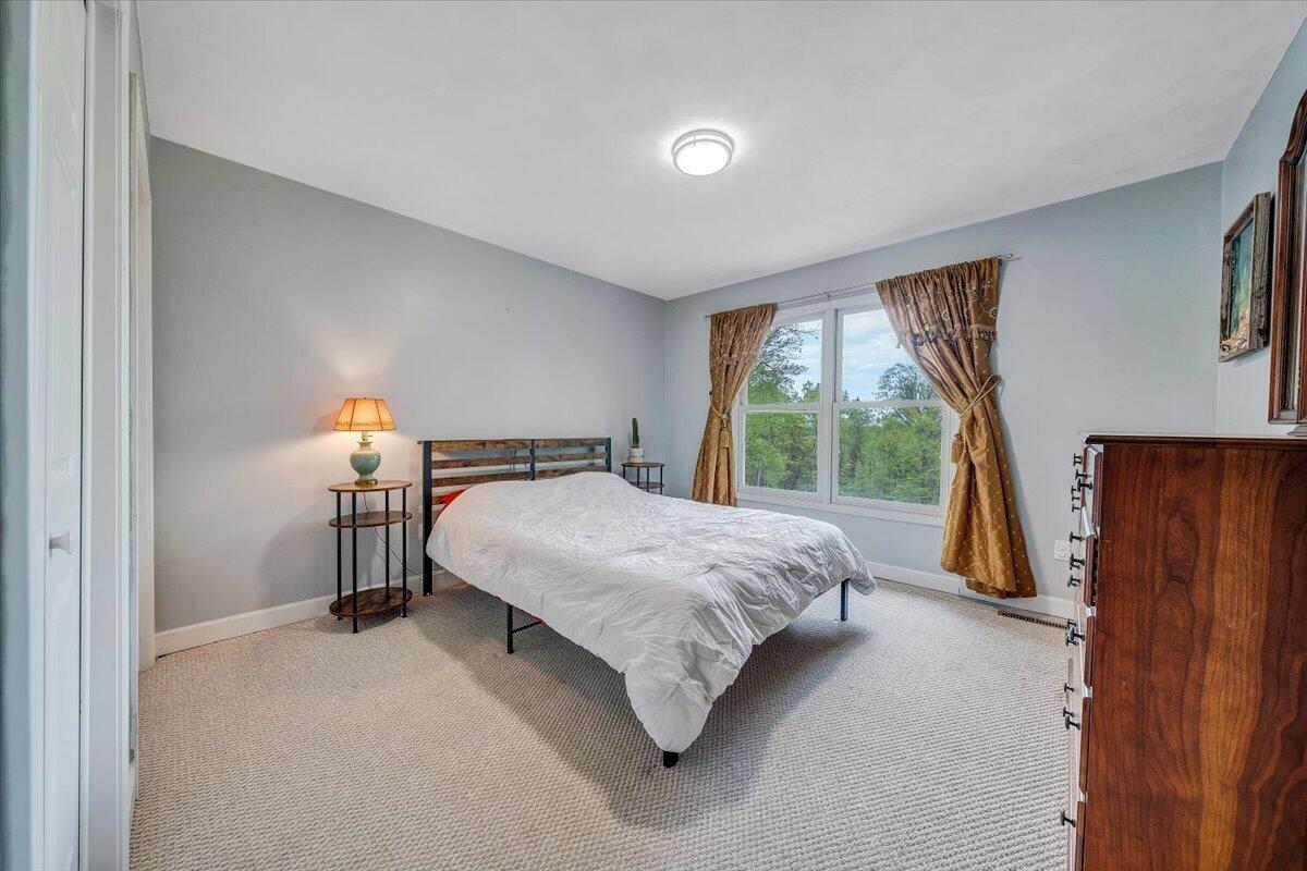856 Ridge Mountain Drive Boones Mill, VA 24065 - Photo 35 of 66 a spacious bedroom with a bed and wooden floor
