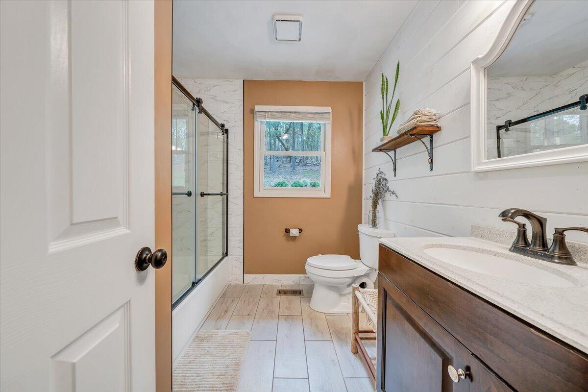 856 Ridge Mountain Drive Boones Mill, VA 24065 - Photo 39 of 66 a bathroom with a granite countertop sink toilet and shower
