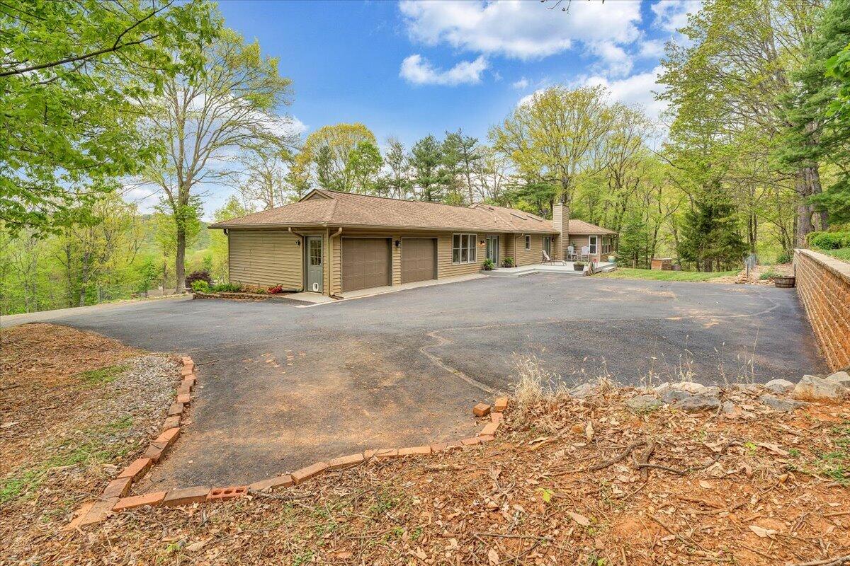 856 Ridge Mountain Drive Boones Mill, VA 24065 - Photo 58 of 66 a front view of a house with a yard and trees
