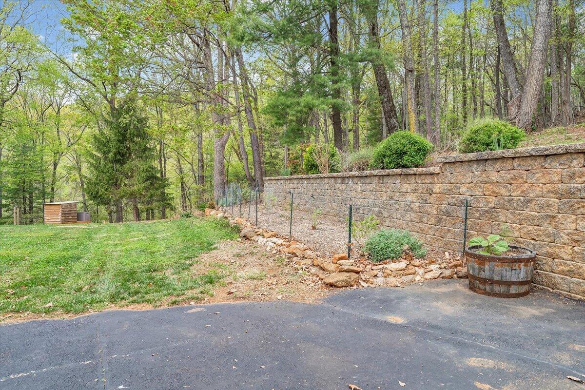 856 Ridge Mountain Drive Boones Mill, VA 24065 - Photo 60 of 66 a backyard of a house with lots of green space and fountain