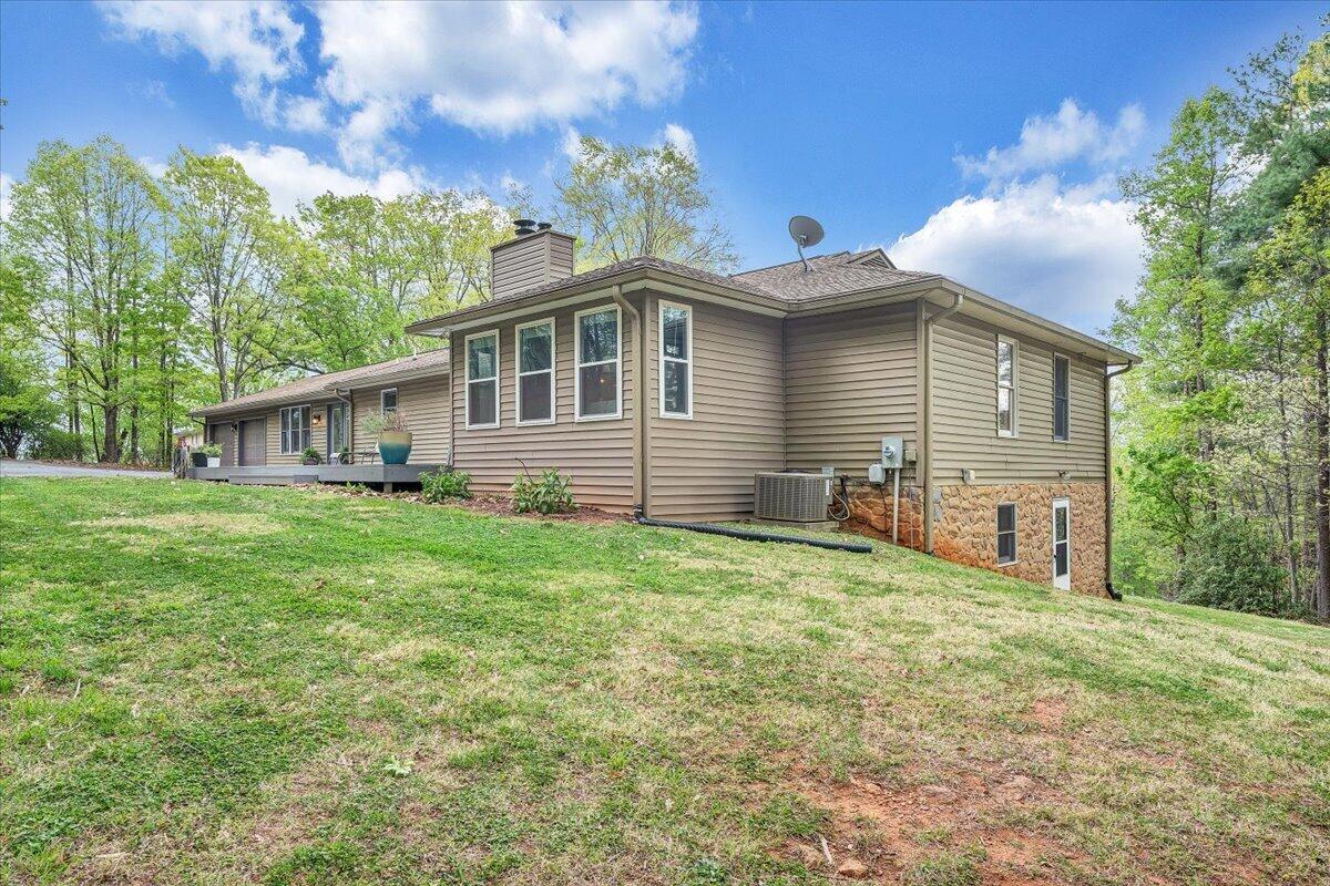 856 Ridge Mountain Drive Boones Mill, VA 24065 - Photo 61 of 66 a front view of a house with a garden