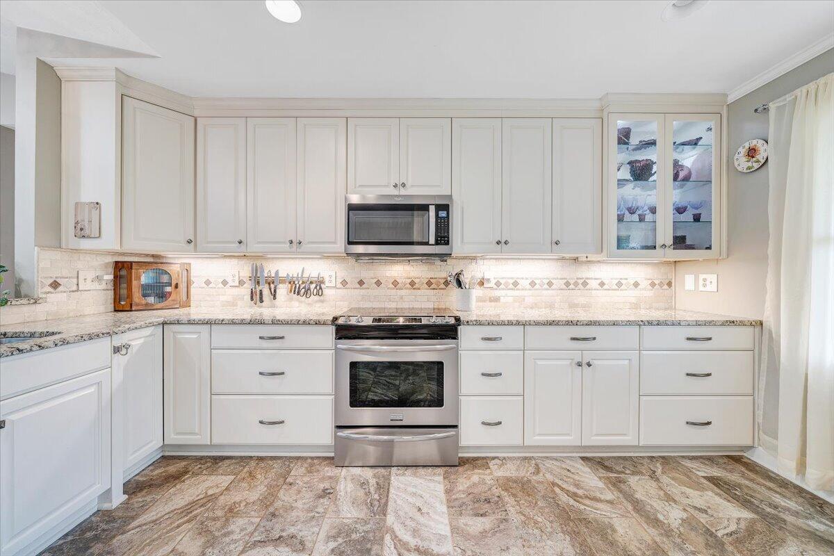 856 Ridge Mountain Drive Boones Mill, VA 24065 - Photo 7 of 66 a kitchen with granite countertop white cabinets and stainless steel appliances