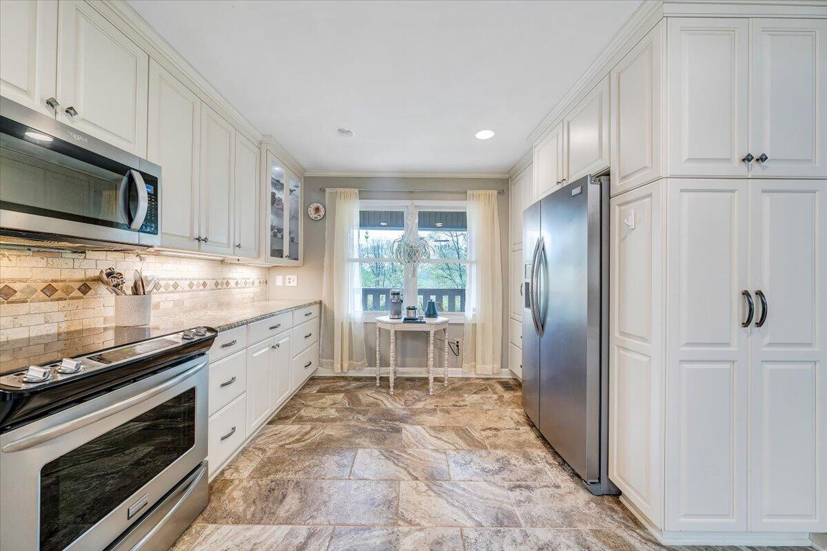 856 Ridge Mountain Drive Boones Mill, VA 24065 - Photo 8 of 66 a large kitchen with cabinets stainless steel appliances and a counter space