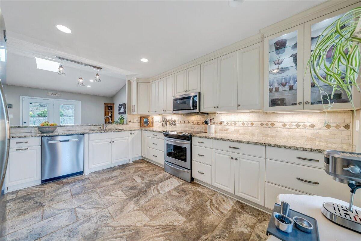856 Ridge Mountain Drive Boones Mill, VA 24065 - Photo 10 of 66 a kitchen with granite countertop white cabinets and white appliances