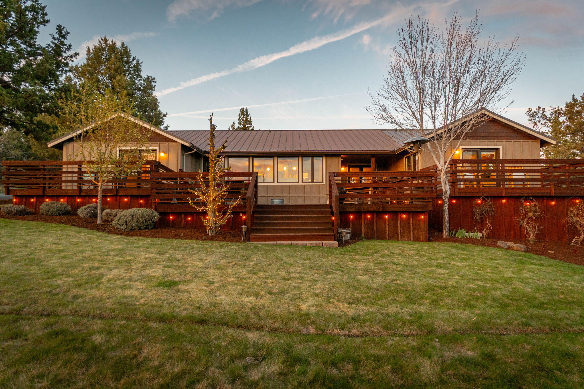 19395 Innes Market Road Bend, OR 97703 - Photo 10 of 75 a view of a house with a big yard and large trees