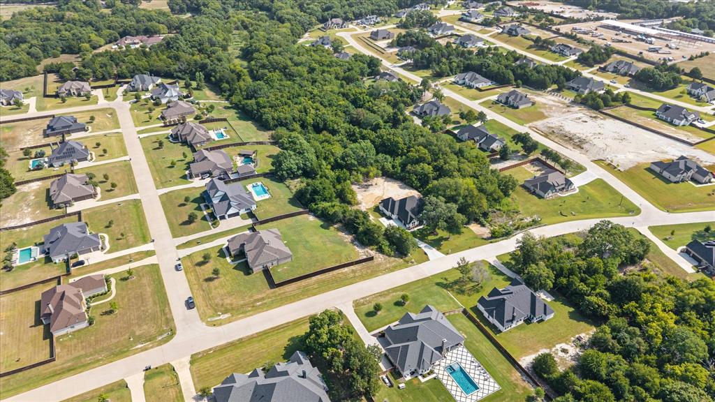 7631 Woodstream Road Midlothian, TX 76065 - Photo 7 of 40 Residential community with established homes, green spaces, paved roadways, and private swimming pools