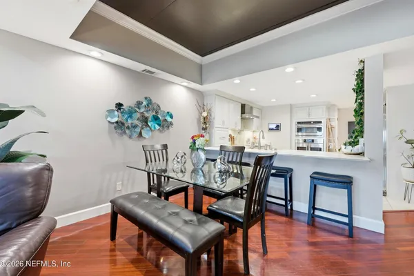 a living room with furniture wooden floor and a flat screen tv