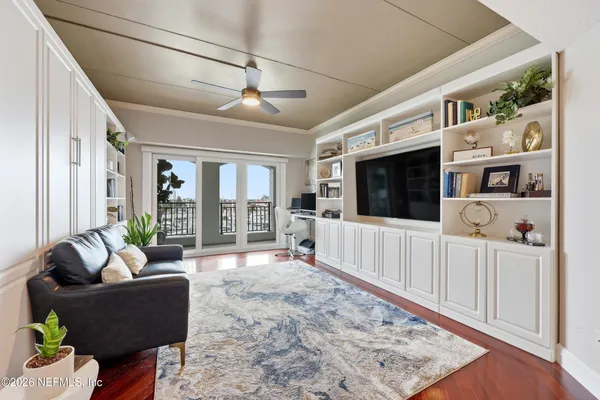 a living room with furniture a piano and a window