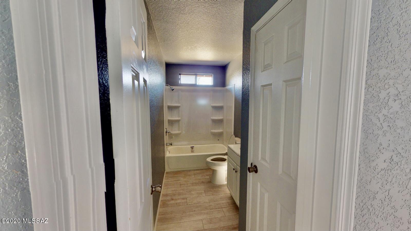 1034 Zorrita Court, Unit CORTE Rio Rico, AZ 85648 - Photo 7 of 16 a bathroom with a glass shower door