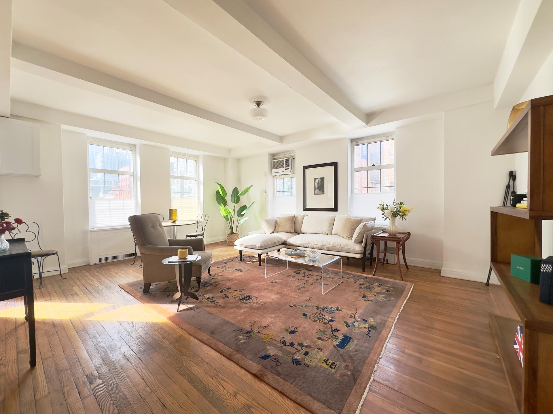 465 West 23rd Street, Unit 3C Manhattan, NY 10011 - Photo 1 of 32 a living room with furniture a rug and a window