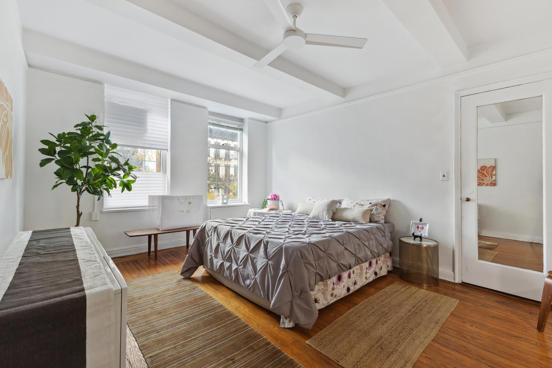 465 West 23rd Street, Unit 3C Manhattan, NY 10011 - Photo 2 of 32 a bedroom with a bed and a potted plant